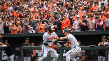 May 19, 2024; Baltimore, Maryland, USA; Baltimore Orioles third baseman Jordan Westburg (11) scores a run and celebrates with outfielder Austin Hays (21) during the first inning against the Seattle Mariners at Oriole Park at Camden Yards.