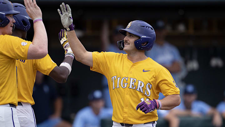 Jun 2, 2024; Chapel Hill, NC, USA; Louisiana State Tigers infielder Josh Pearson (11) is welcomed at home plate after hitting a home run against the North Carolina Tar Heels during the Div. I NCAA baseball regional at Boshamer Stadium.  Mandatory Credit: Jeffrey Camarati-Imagn Images