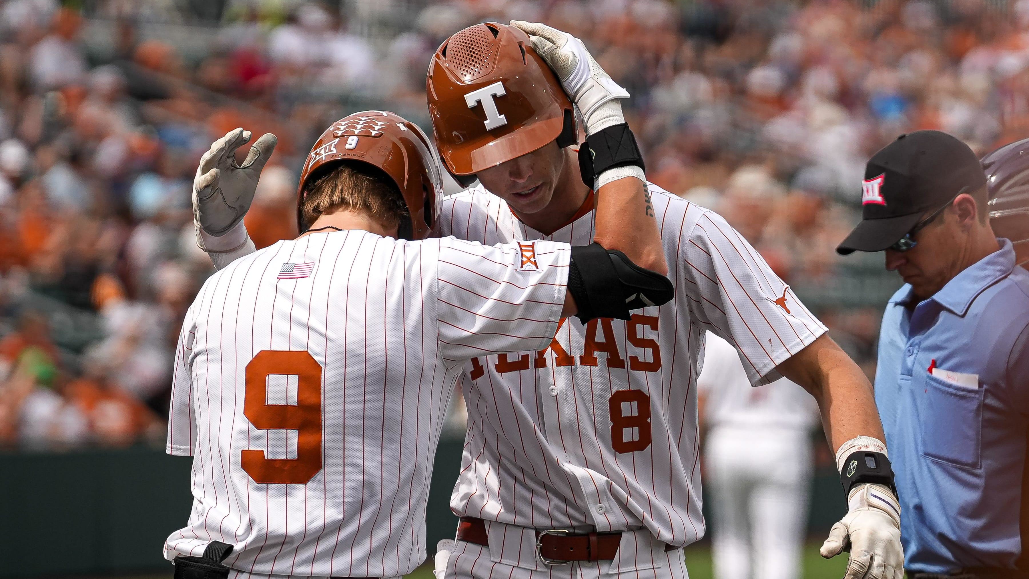 Texas Longhorns outfielder Jared Thomas (9) celebratees a home run by outfielder Will Gasparino (8)