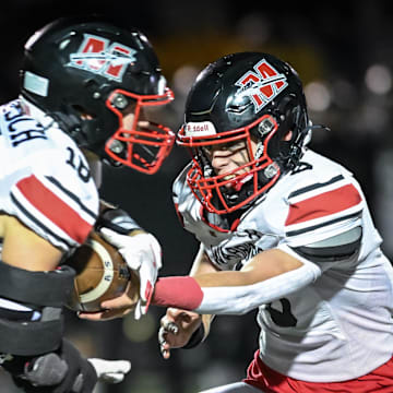 Muskego quarterback Joey Shaw (8) hands off to running back Jack Labisch (18) in a Level 2 playoff game against Franklin on Friday, November 1, 2024, at Franklin High School in Franklin, Wisconsin.