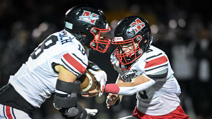 Muskego quarterback Joey Shaw (8) hands off to running back Jack Labisch (18) in a Level 2 playoff game against Franklin on Friday, November 1, 2024, at Franklin High School in Franklin, Wisconsin.