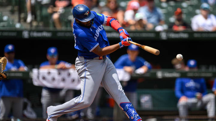 Jul 31, 2024; Baltimore, Maryland, USA; Toronto Blue Jays first baseman Vladimir Guerrero Jr. (27) hits a single against the Baltimore Orioles during the first inning at Oriole Park at Camden Yards. Mandatory Credit: Reggie Hildred-USA TODAY Sports