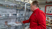 Owner Scott Fitzgerald shows baseball cards at Vintage Indy Sports, 