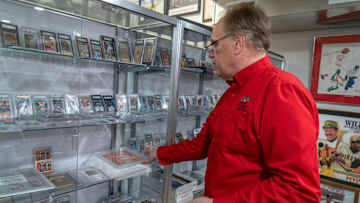 Owner Scott Fitzgerald shows baseball cards at Vintage Indy Sports, 