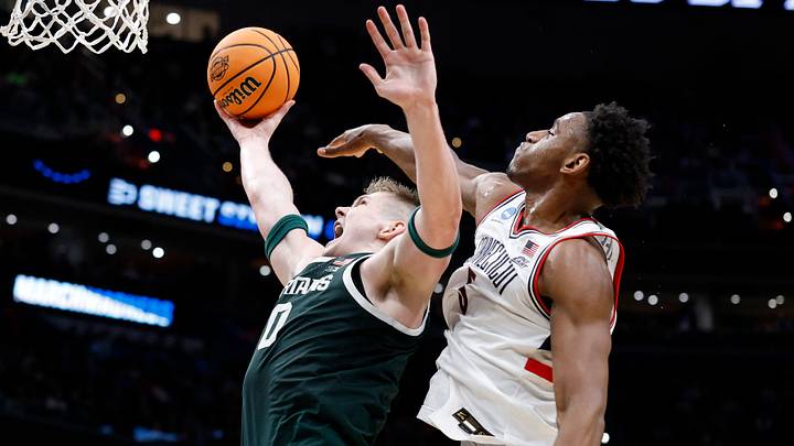 Mar 27, 2026; Washington, DC, USA; Michigan State Spartans forward Jaxon Kohler (0) shoots the ball past UConn Huskies forward Tarris Reed Jr. (5) in the first half during a Sweet Sixteen game of the East Regional of the men's 2026 NCAA Tournament at Capital One Arena. Mandatory Credit: Amber Searls-Imagn Images