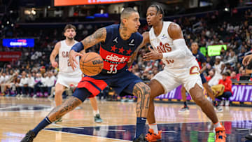 Oct 26, 2024; Washington, District of Columbia, USA; Washington Wizards forward Kyle Kuzma (33) dribbles the ball against Cleveland Cavaliers forward Isaac Okoro (35) during the second quarter at Capital One Arena. Mandatory Credit: Reggie Hildred-Imagn Images