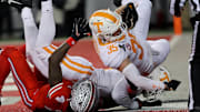 Dec 21, 2024; Columbus, Ohio, USA;  Ohio State Buckeyes wide receiver Jeremiah Smith (4) has a ball deflected to Tennessee Volunteers defensive back Will Brooks (35) who completes the interception during the second quarter at Ohio Stadium. Mandatory Credit: Joseph Maiorana-Imagn Images