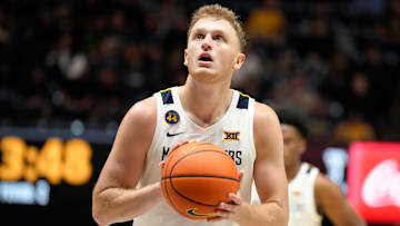 Tucker DeVries #12 of the West Virginia Mountaineers takes a foul shot during an exhibition college basketball game against the Charleston Golden Eagles at WVU Coliseum on October 18, 2024 in Morgantown, West Virginia.