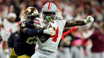 Ohio State Buckeyes wide receiver Jeremiah Smith (4) makes a catch against Notre Dame Fighting Irish cornerback Christian Gray (29) in the fourth quarter during the College Football Playoff National Championship at Mercedes-Benz Stadium in Atlanta on January 20, 2025.