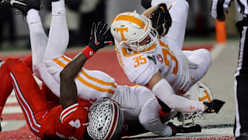 Dec 21, 2024; Columbus, Ohio, USA;  Ohio State Buckeyes wide receiver Jeremiah Smith (4) has a ball deflected to Tennessee Volunteers defensive back Will Brooks (35) who completes the interception during the second quarter at Ohio Stadium. Mandatory Credit: Joseph Maiorana-Imagn Images