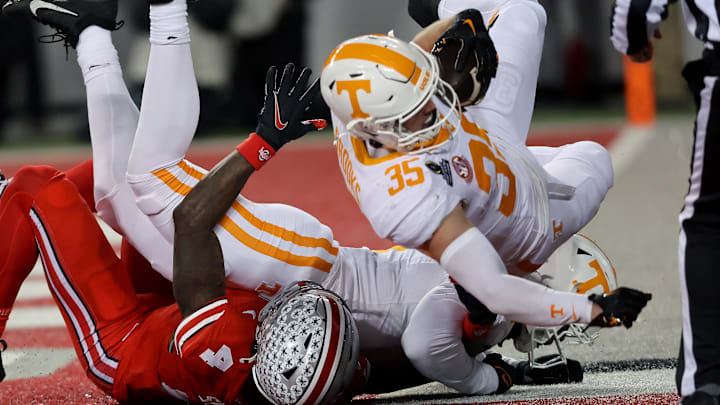 Dec 21, 2024; Columbus, Ohio, USA;  Ohio State Buckeyes wide receiver Jeremiah Smith (4) has a ball deflected to Tennessee Volunteers defensive back Will Brooks (35) who completes the interception during the second quarter at Ohio Stadium. Mandatory Credit: Joseph Maiorana-Imagn Images