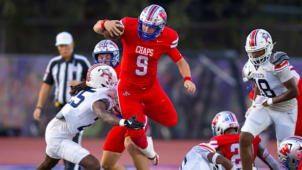 Westlake QB Rees Wise (9) battles Atascosita defenders in a Texas 6A football game on Friday at Westlake High School.