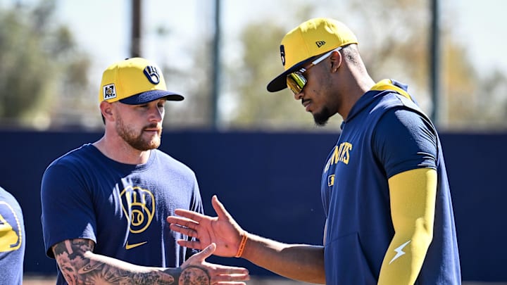 Milwaukee Brewers infielder Brice Turang (2), left, shakes hands with infielder Ernesto Martinez Jr. during spring training workouts Saturday, February 15, 2025, at the American Family Fields of Phoenix in Phoenix, Arizona.