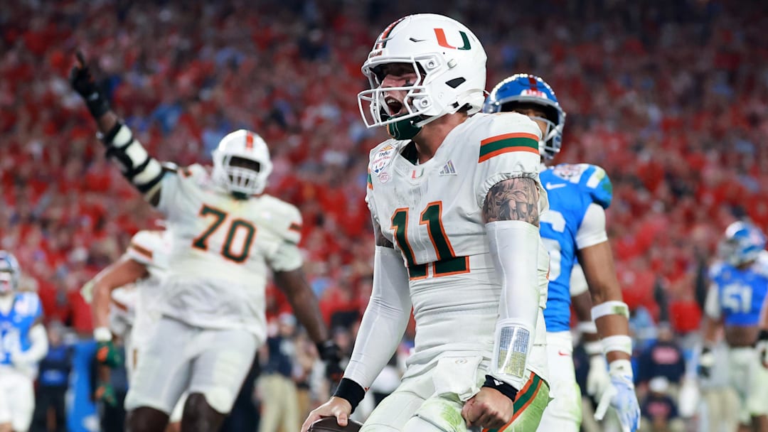 Jan 8, 2026; Glendale, AZ, USA; Miami  Hurricanes quarterback Carson Beck (11) rushes for a touchdown against the Mississippi Rebels in the second half during the 2026 Fiesta Bowl and semifinal game of the College Football Playoff at State Farm Stadium. Mandatory Credit: Mark J. Rebilas-Imagn Images