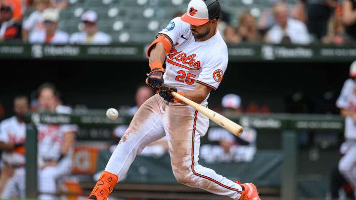 Jul 31, 2024; Baltimore, Maryland, USA; Baltimore Orioles outfielder Anthony Santander (25) hits a single against the Toronto Blue Jays during the fifth inning at Oriole Park at Camden Yards. Mandatory Credit: Reggie Hildred-USA TODAY Sports