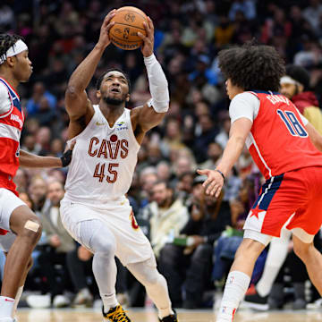 Feb 7, 2025; Washington, District of Columbia, USA; Cleveland Cavaliers guard Donovan Mitchell (45) drives to the basket against Washington Wizards forward Kyshawn George (18) and guard Bilal Coulibaly (0) during the third quarter at Capital One Arena. Mandatory Credit: Reggie Hildred-Imagn Images