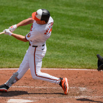 Jul 31, 2024; Baltimore, Maryland, USA; Baltimore Orioles second baseman Jackson Holliday (7) hits a home run against the Toronto Blue Jays during the fifth inning at Oriole Park at Camden Yards.