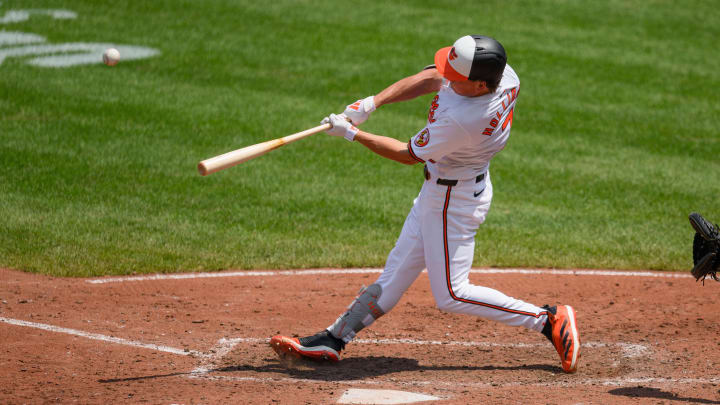 Jul 31, 2024; Baltimore, Maryland, USA; Baltimore Orioles second baseman Jackson Holliday (7) hits a home run against the Toronto Blue Jays during the fifth inning at Oriole Park at Camden Yards.