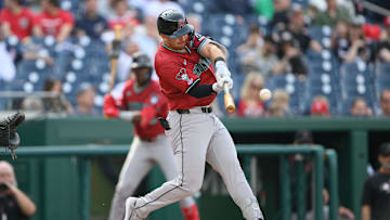 Apr 5, 2025; Washington, District of Columbia, USA; Arizona Diamondbacks second baseman Tim Tawa (13) hits a single during the third inning against the Washington Nationals at Nationals Park. Mandatory Credit: Reggie Hildred-Imagn Images