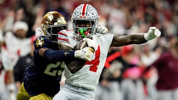 Ohio State Buckeyes wide receiver Jeremiah Smith (4) makes a catch against Notre Dame Fighting Irish cornerback Christian Gray (29) in the fourth quarter during the College Football Playoff National Championship at Mercedes-Benz Stadium in Atlanta on January 20, 2025.