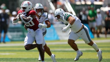 Aug 23, 2025; Honolulu, Hawaii, USA; Hawaii Rainbow Warriors defensive back Peter Manuma (1) tries to pull down Stanford Cardinal running back Micah Ford (20) during the first half of an NCAA college football game at Clarence T.C. Ching Athletics Complex. Mandatory Credit: Marco Garcia-Imagn Images