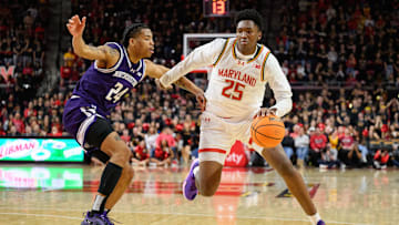 Mar 8, 2025; College Park, Maryland, USA; Maryland Terrapins center Derik Queen (25) handles the ball against Northwestern Wildcats guard K.J. Windham (24) during the second half at Xfinity Center. Mandatory Credit: Reggie Hildred-Imagn Images