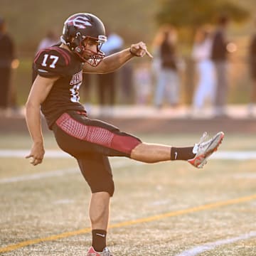 Kenosha Bradford's Tomas Cesari (17) launches a punt past Franklin defensive back Jackson Bouldry (12) in Southeast Conference game Friday, September 26, 2025.