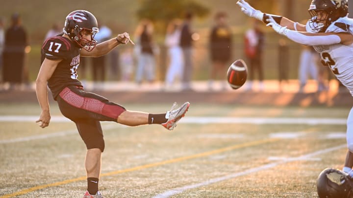 Kenosha Bradford's Tomas Cesari (17) launches a punt past Franklin defensive back Jackson Bouldry (12) in Southeast Conference game Friday, September 26, 2025.