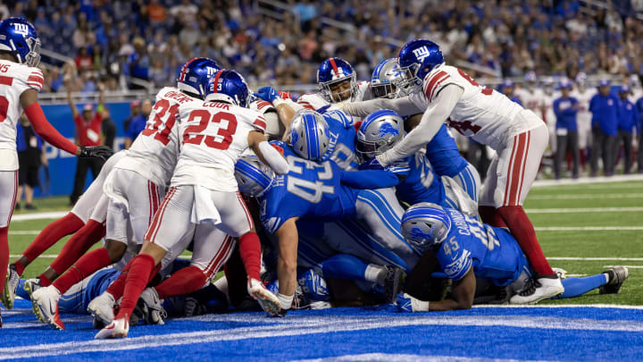 Detroit Lions quarterback Adrian Martinez (18) scores the game winning touchdown against the New York Giants 