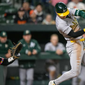 Apr 26, 2024; Baltimore, Maryland, USA; Oakland Athletics outfielder Brent Rooker (25) hits a double during the tenth inning against the Baltimore Orioles at Oriole Park at Camden Yards. Mandatory Credit: Reggie Hildred-USA TODAY Sports