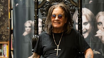 Ozzy Osbourne signs copies of an album