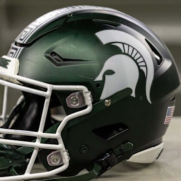 Nov 24, 2023; Detroit, Michigan, USA; A Michigan State Spartans helmet sits on a bench during the second half game against the Penn State Nittany Lions at Ford Field. Mandatory Credit: David Reginek-Imagn Images