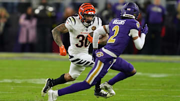 Nov 27, 2025; Baltimore, Maryland, USA; Cincinnati Bengals running back Chase Brown (30) rushes the ball against Baltimore Ravens cornerback Nate Wiggins (2) during the first half at M&T Bank Stadium. Mandatory Credit: Mitch Stringer-Imagn Images