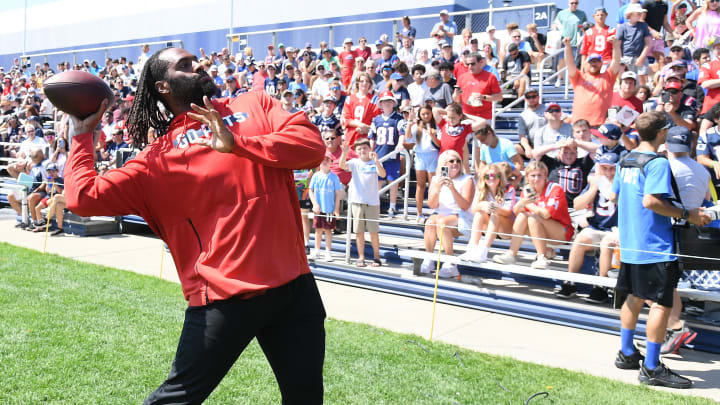 Jul 26, 2024; Foxborough, MA, USA; New England Patriots linebacker Matthew Judon (9) tosses a ball to fans during training camp at Gillette Stadium. Mandatory Credit: Eric Canha-USA TODAY Sports