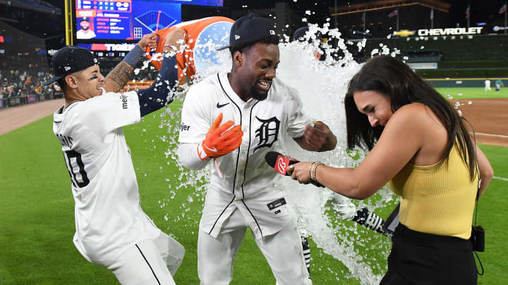 Aug 14, 2024; Detroit, Michigan, USA;  Detroit Tigers outfielder Akil Baddoo (60) gets an unexpected ice bath from teammates Bligh Madris (40) and Jake Rogers (34) while doing a post-game interview after hitting a game-winning walk-off double against the Seattle Mariners in the tenth inning at Comerica Park.