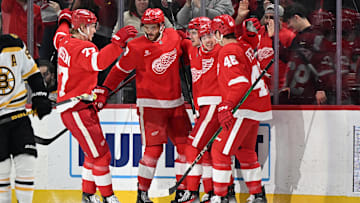 Mar 29, 2025; Detroit, Michigan, USA;  Detroit Red Wings center Marco Kasper (92) celebrates with his teammates  defenseman Simon Edvinsson (77) center Michael Rasmussen (27) left wing Lucas Raymond (23) and defenseman Jeff Petry (46) after scoring a goal against the Boston Bruins in the first period at Little Caesars Arena. Mandatory Credit: Lon Horwedel-Imagn Images