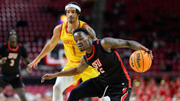 Dec 17, 2024; College Park, Maryland, USA; St. Francis (Pa) Red Flash guard Daemar Kelly (5) drives to the basket against Maryland Terrapins guard Rodney Rice (1) during the first half at Xfinity Center. Mandatory Credit: Reggie Hildred-Imagn Images