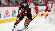 Mar 4, 2025; Detroit, Michigan, USA;  Carolina Hurricanes right wing Mikko Rantanen (96) steers the puck away from Detroit Red Wings defenseman Justin Holl (3) in the first period at Little Caesars Arena. Mandatory Credit: Lon Horwedel-Imagn Images