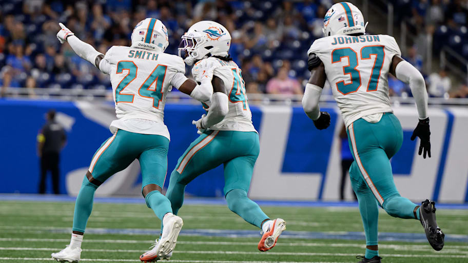 Miami Dolphins cornerback Ethan Robinson (46) celebrates with teammates Cam Smith (24) and Isaiah Johnson (37) after intercepting a pass against the Detroit Lions in the fourth quarter at Ford Field on Sunday. | Lon Horwedel-Imagn Images