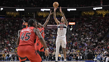 Oct 6, 2024; Montreal, Quebec, CAN; Washington Wizards small forward Kyle Kuzma (33) takes a jump shot and Toronto Raptors shooting guard RJ Barrett (9) defends during the first quarter at the Bell Centre. Mandatory Credit: Eric Bolte-Imagn Images