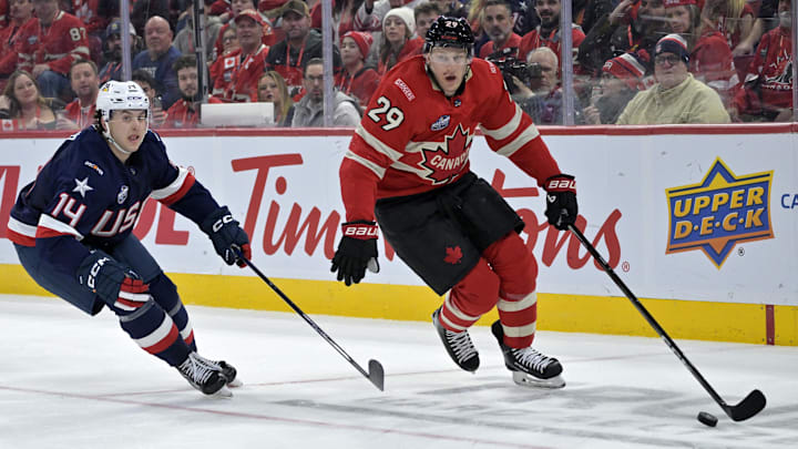 Feb 15, 2025; Montreal, Quebec, CAN; [Imagn Images direct customers only] Team Canada forward Nathan MacKinnon (29) plays the puck and Team United States defenseman Brock Faber (14) defends in the second period during a 4 Nations Face-Off ice hockey game at the Bell Centre. Mandatory Credit: Eric Bolte-Imagn Images
