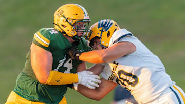 Howell's Bobby Kanka (left) works against Hudsonville's Cooper Roberts Thursday, Aug. 29, 2024.