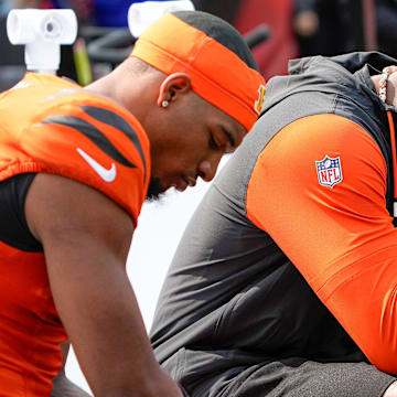 Cincinnati Bengals Ja'Marr Chase and Tee Higgins who was inactive for the Bengals sit on the sideline as their team is defeated by the New England Patriots 16-10 at Paycor Stadium Sunday, September 8, 2024.