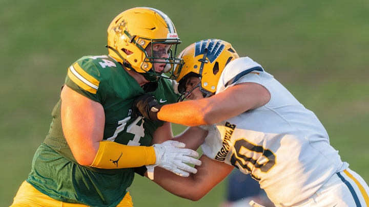 Howell's Bobby Kanka (left) works against Hudsonville's Cooper Roberts Thursday, Aug. 29, 2024.