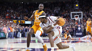 Jan 25, 2025; Auburn, Alabama, USA;  Auburn Tigers forward Chaney Johnson (31) drives against Tennessee Volunteers forward Felix Okpara (34) during the second half at Neville Arena.  Auburn came from behind in the last minute to win the game. Mandatory Credit: John Reed-Imagn Images