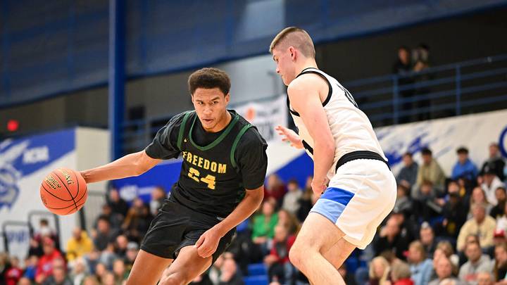 Freedom forward Donovan Davis (24) drives to the basket against the defense of Brookfield Central forward Henry Gruetzmacher (31) in the Rick Majerus WBY Shootout on Saturday, December 27, 2025, at Concordia University in Mequon, Wisconsin. Freedom won, 74-58.