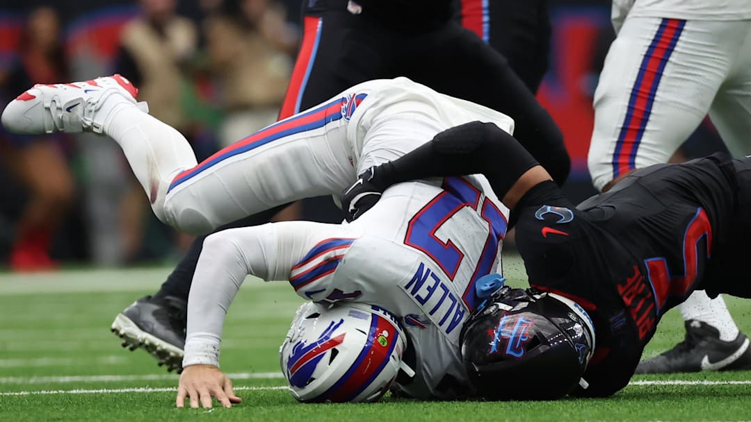 Oct 6, 2024; Houston, Texas, USA;  Buffalo Bills quarterback Josh Allen (17) gets hit by Houston Texans safety Jalen Pitre (5) in the second half at NRG Stadium.