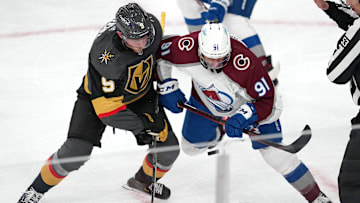 Feb 26, 2022; Las Vegas, Nevada, USA; The puck bounces as Vegas Golden Knights center Jack Eichel (9) and Colorado Avalanche center Nazem Kadri (91) take a third period face off at T-Mobile Arena. Mandatory Credit: Stephen R. Sylvanie-Imagn Images