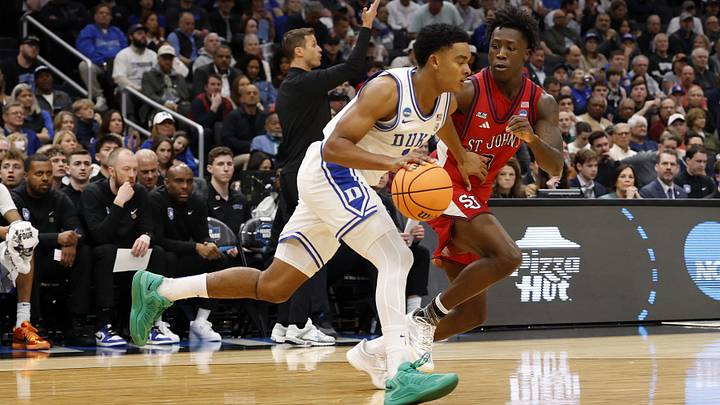 Mar 27, 2026; Washington, DC, USA; Duke Blue Devils guard Caleb Foster (1) dribbles the ball past St. John's Red Storm guard Joson Sanon (3) in the first half during a Sweet Sixteen game of the East Regional of the men's 2026 NCAA Tournament at Capital One Arena. Mandatory Credit: Geoff Burke-Imagn Images