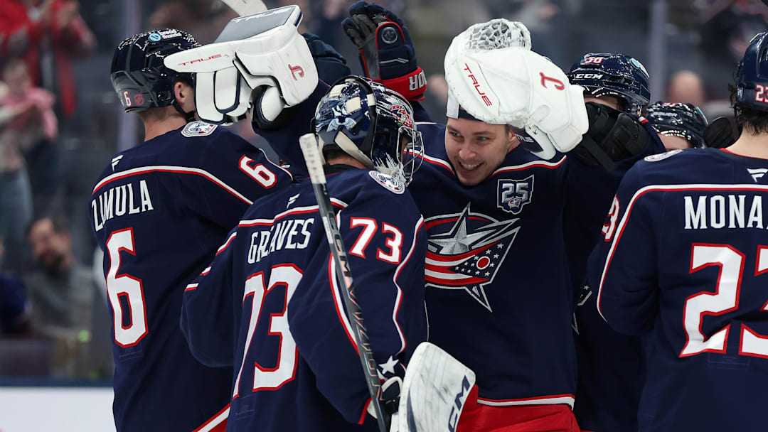 Elvis Merzlikins celebrates with Jet Greaves following a win at Nationwide Arena